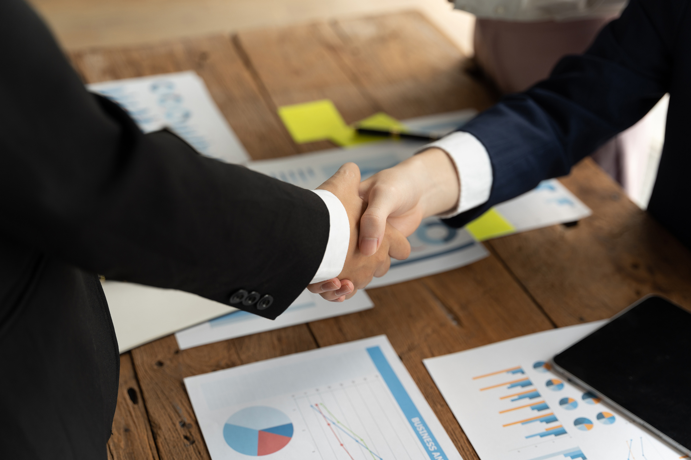 Close up of Business people shaking hands, finishing up meet